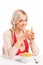 A female drinking a juice and eating cornflakes