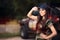 Female Driver in Army Outfit Next to an Off Road Car