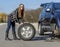 Female driver repairs car