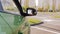 A female driver throws an empty plastic bottle through the window of a car parked in the parking lot.