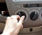 Female driver turning car air conditioner knob