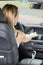 female driver turning on navigational system in car