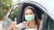 The female driver wearing surgical mask felt confident and gesturing thumbs up while traveling