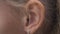 Female ear with earring close up. Ear of woman blonde with decorative piercing