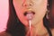 Female eating sparkling shimmer lollipop