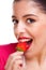 Female eating strawberry