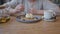 female eating sweet creamy cake cafe from purple plate wooden table hand spoon