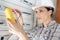 female electrical worker installing fuse box