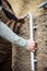 female electrician installs cable outside on a house wall