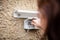 female electrician installs a socket outside in the garden