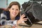 Female electrician working on appliance