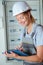 Female electrician writing on clipboard