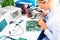 Female electronic engineer checking circuit board in laboratory