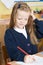 Female Elementary Pupil Suffering From Head Lice In Classroom