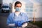 Female emergency services doctor in front of ambulance clinic