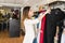 Female Employee Arranging Clothes At Shop