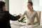 Female employee handshaking with male client