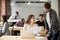 Female employee helping male colleague with documents in shared