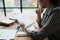 female employee holds a pen and checks investment financial documents.