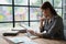 female employee holds a pen and checks investment financial documents.