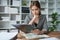 female employee holds a pen and checks investment financial documents.