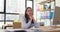 Female employee of successful corporation sits at desk