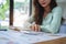 female employee using a calculator to calculate financial documents