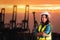 Female engineer standing infront sea port cargo crane harbor terminal