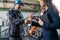 Female engineering manager and mechanic worker fist bumping in industrial factory