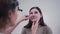 Female ENT doctor examines patient\'s sinuses with medical instrument in modern clinic. Otorhinolaryngologist checks the