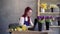 female entrepreneur, female florist working on laptop, ordering plants. A young business woman in an apron checks