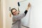 A female entrepreneur or teacher writing on a blackboard with an erasable presentation marker in a conference room