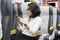 Female entrepreneur using a phone in train