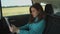 Female entrepreneur works on digital tablet in car