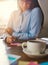 Female entrepreneur writing notes at desk