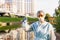 Female epidemiologist looking at the camera holding a test tube with water from a city river