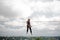 Female equilibrist sitting on the slackline rope