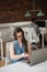 Female executive adjusting smart watch at desk