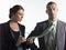 Female Executive Cleaning Glasses On Tie Of Businessman