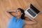 Female executive relaxing with hands behind head on the floor