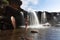 Female exploring and enjoying waterfalls and rock pools in nature