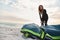 Female Extreme Sports Kite Surfer Prepping Kite On Beach