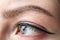 Female eye of blue color of a young girl close-up. Eye and eyebrow makeup.Permanent makeup for eyelids and eyebrows