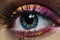 Female eye with bright and colorful makeup with eye shadow, mascara and contact lenses close-up, AI Generated