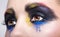 Female eye with unusual artistic painting makeup