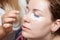 Female eyelashes dyeing with permanent blue makeup