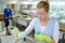 Female factory worker cleaning objects