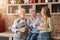 Female family drinking tea and laughing at kitchen