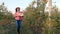 Female farmer with apples. Apple harvest. Happy woman carries a box of freshly picked apples. backdrop of apple farm