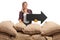 Female farmer behind burlap sacks with an arrow